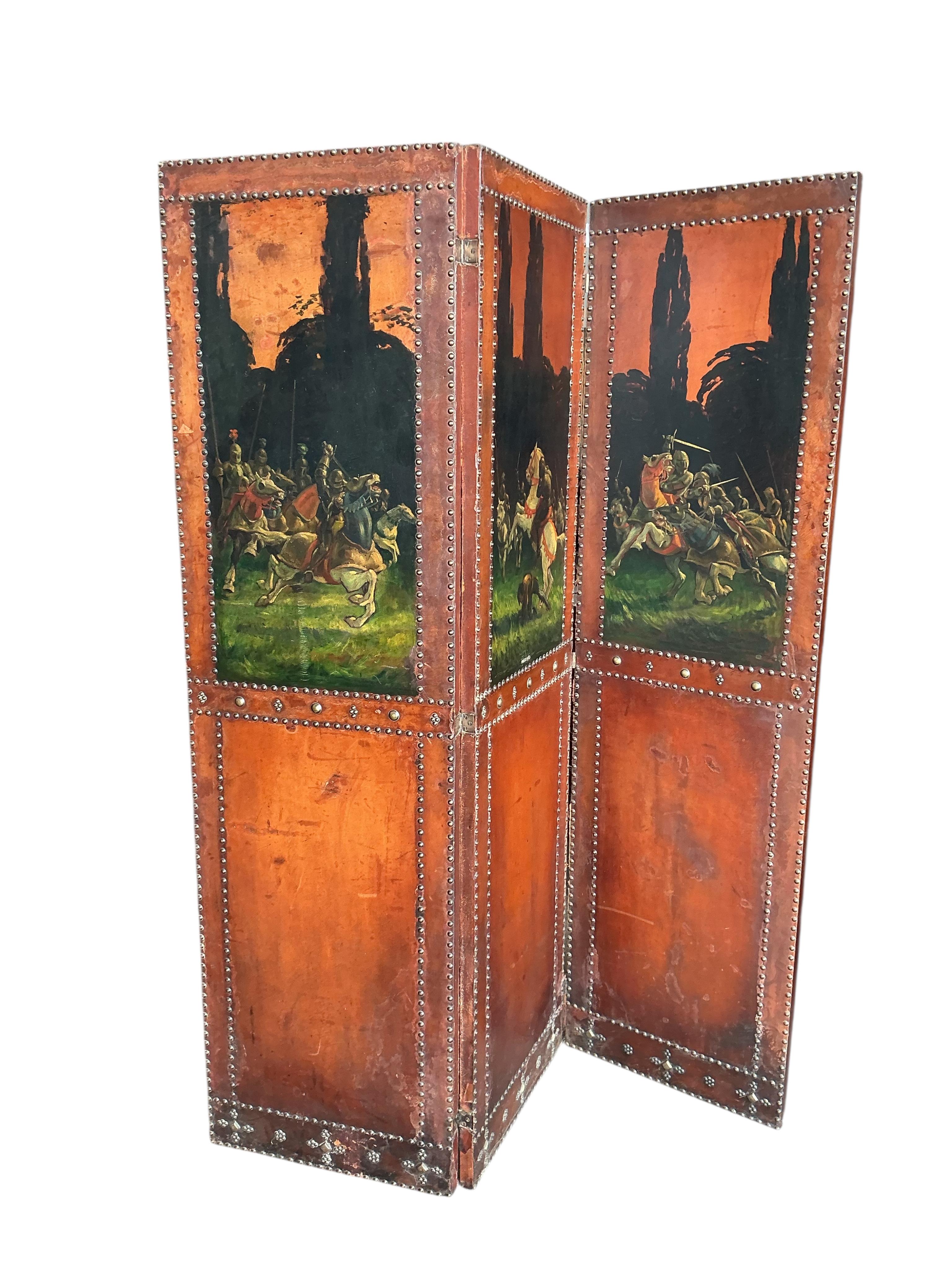 A painted leather and mahogany three fold dressing screen, each panel width 48cm, height 174cm